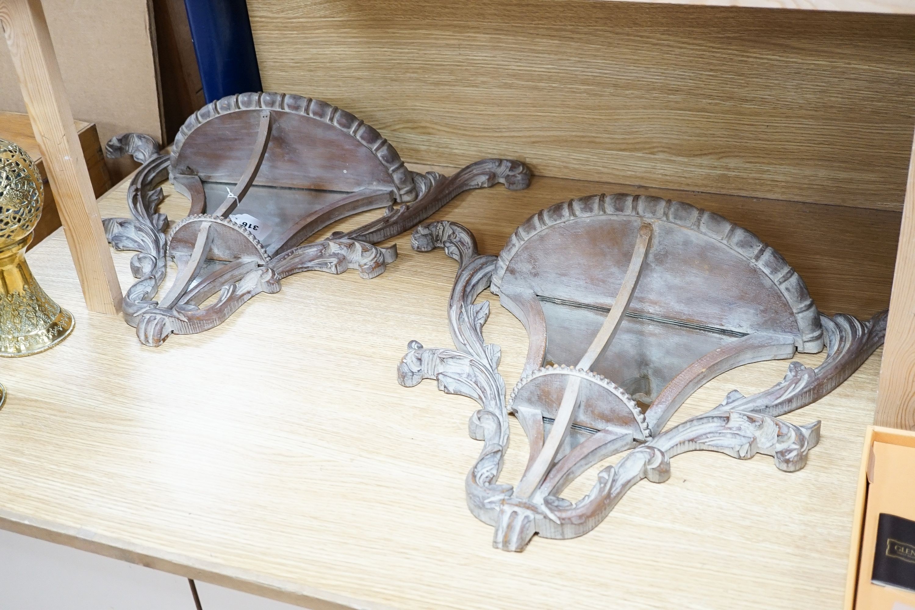 A pair of early 20th century mirror backed carved beech wall brackets 50cm